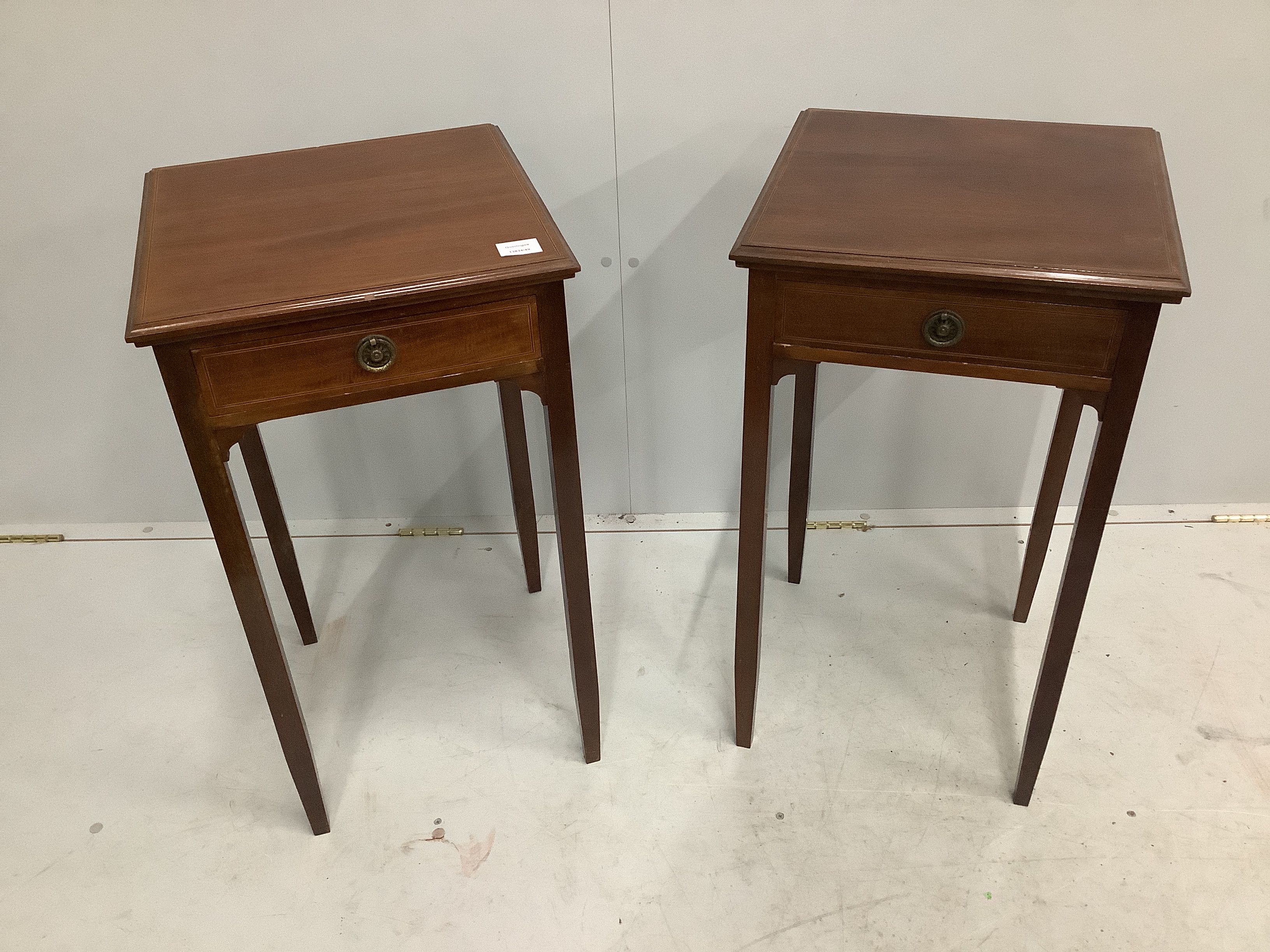 A pair of reproduction George III style mahogany bedside tables, with blind fret aprons, on square moulded legs, width 40cm, depth 40cm, height 73cm